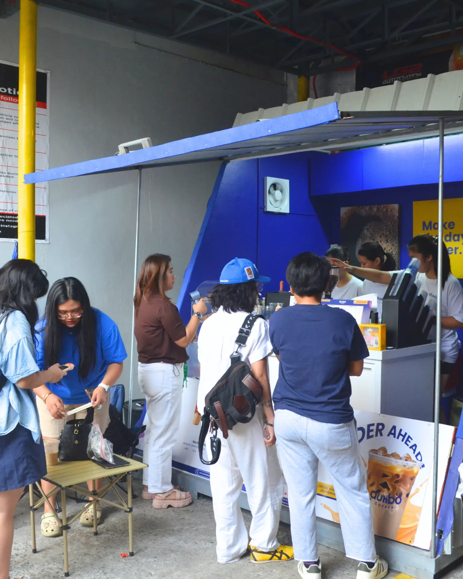 Customers and team members gathered around a Dumbo Coffee counter